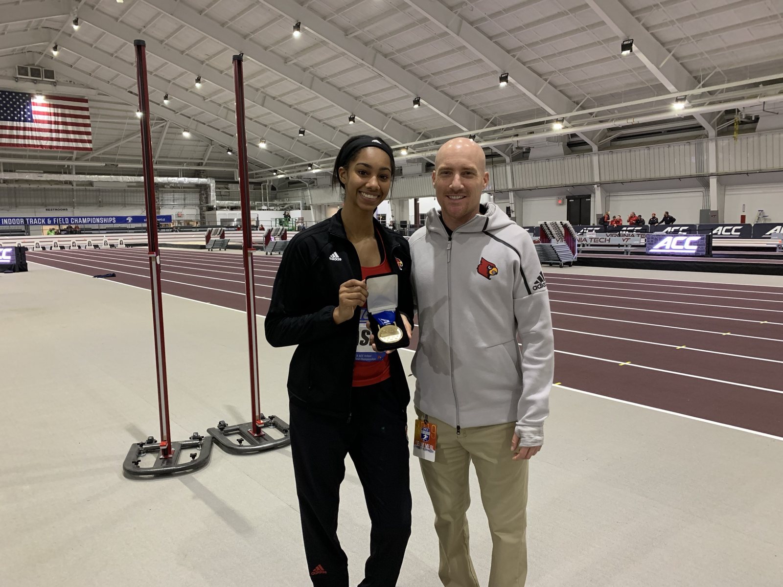 Jeff with a champion athlete holding her medal at the ACC Indoor Championships